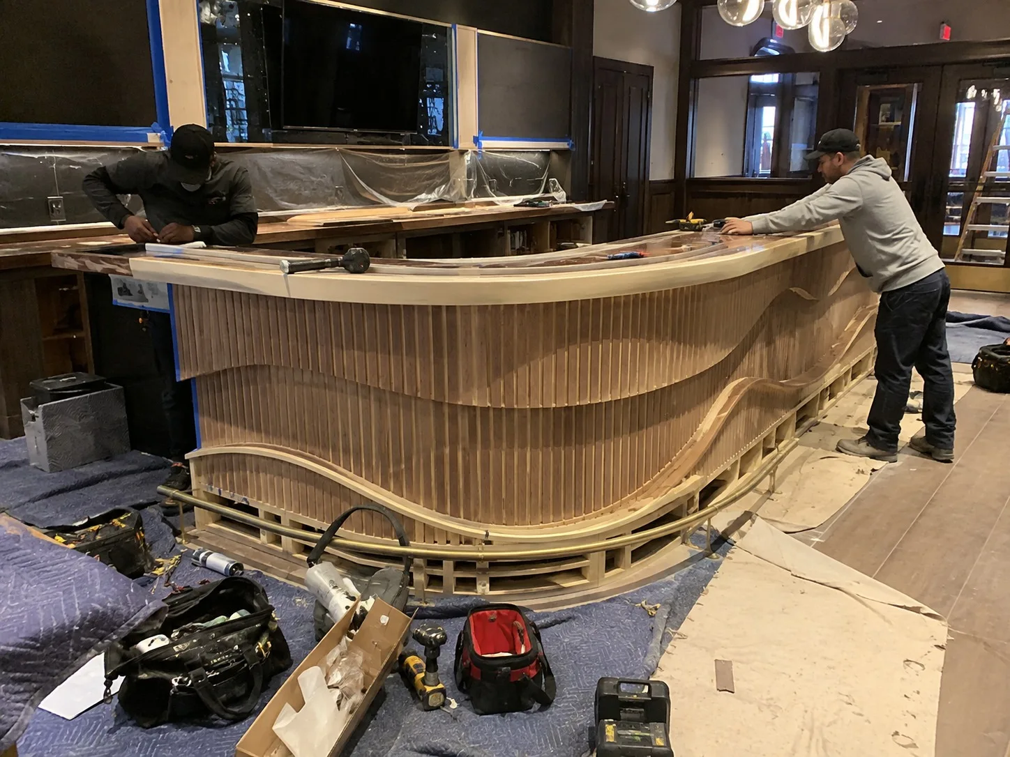 Custom bar with curved timber front in a Miami dining room