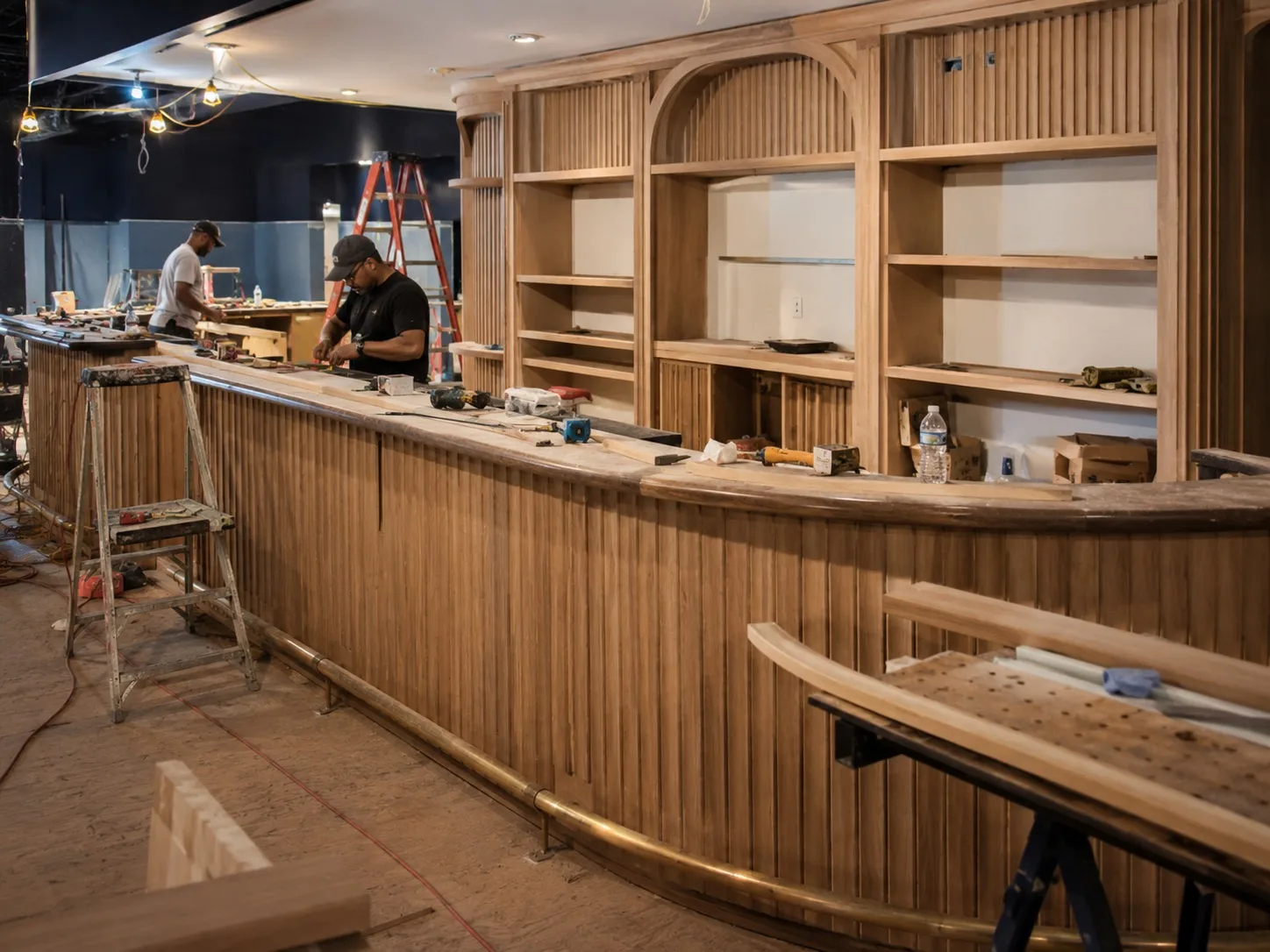 Custom bar millwork for a Miami hospitality venue with glass shelving